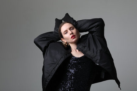 Gorgeous young woman posing over white wall. Vertical mock-up.Isolated.の写真素材