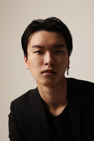 Fashion and confident young asian man posing on the white background. Vertical.の写真素材