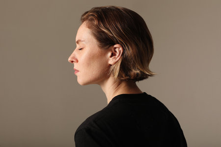 Side-view of sensual woman poses isolated indoor. Mental health issues.の写真素材