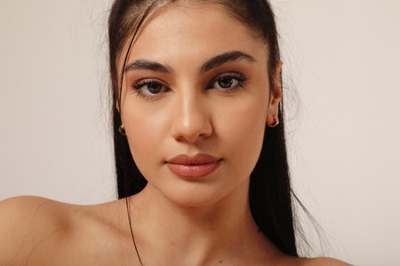 Close-up of beautiful young woman with soft make-up and perfect skin over white.の写真素材