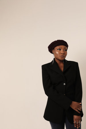 Muslim young woman wearing hijab posing indoor. Vertical portrait.の写真素材
