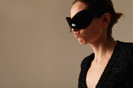 Portrait of confident young woman wearing sunglasses posing indoor. Mock-up.の写真素材