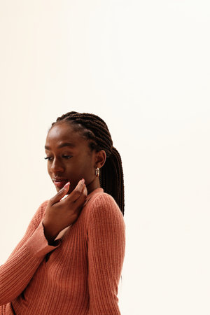 Young fashionable woman posing over white background looking away. Verticalの写真素材