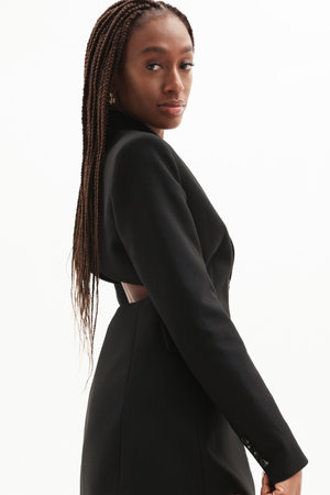 Fashionable woman posing over white background looking at the camera. Verticalの写真素材