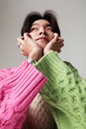 Mind set and mental health. Vertical close-up of young Asian man posing indoor.の写真素材