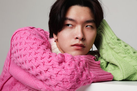 Close-up of young Asian man looking away. Mind set and mental attitude.の写真素材