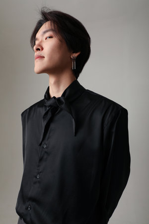Confident young Asian man looking at the camera. Vertical mock-up. Mind set.の写真素材