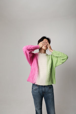 Confident young Asian man cover his face with hands. Vertical mock-up. Mind set.の写真素材