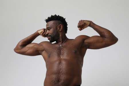 African American athletic man with doing neck stretching exercises. Mock-up.の写真素材