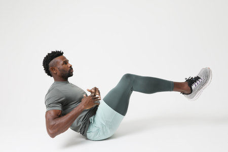 Portrait of athletic young man doing muscle stretching exercises. Mock-up.の写真素材
