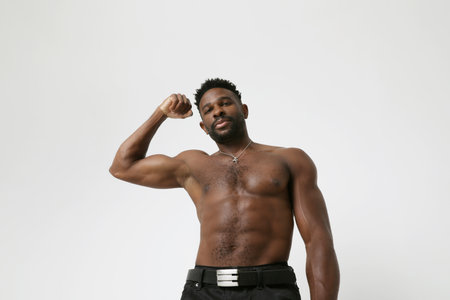 African American athletic young man with doing muscle exercises. Mock-up.の写真素材