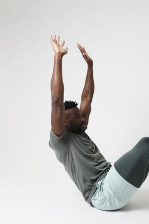 Portrait of athletic man doing muscle stretching exercises. Vertical mock-up.の写真素材
