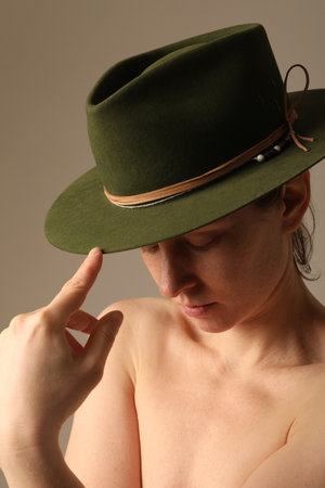 Close-up of confident young woman wearing green hat. Vertical mock-up.の写真素材