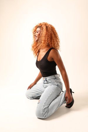 Cool girl. Beautiful African young woman with afro hairstyle posing indoor.の写真素材