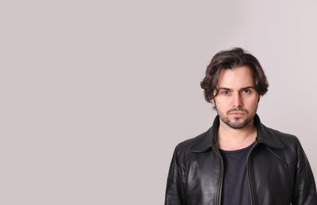 Close-up of handsome man looking at the camera isolated on white wall. Mock-up.の写真素材