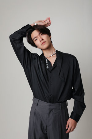 Confident young Asian man with calm face expression. Vertical mock-up. Mind set.の写真素材