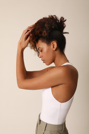 Side view of beautiful African American young woman with curly hair. Mock-up.の写真素材