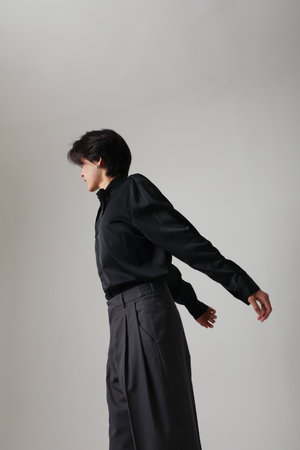 Confident young Asian man posing at the studio. Vertical mock-up. Mind set.の写真素材
