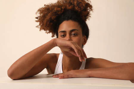 Beautiful African American young woman with curly hair looking at the camera.の写真素材