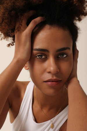 Portrait of beautiful African American young woman with curly hair. Mock-up.の写真素材