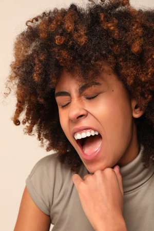 Mental health issue. African American young woman screaming with eyes closed.の写真素材