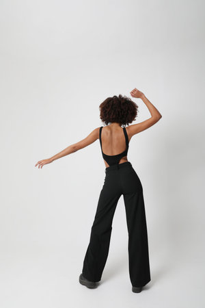 Dancing and living. Beautiful African American young woman with curly hair.の写真素材