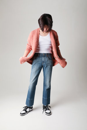 Confident fashion young man posing indoor over white background. Mock-up.の写真素材
