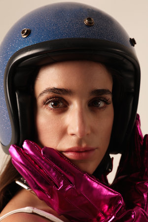 Vertical close-up of young woman wearing blue biker helmet. Mock-up.の写真素材