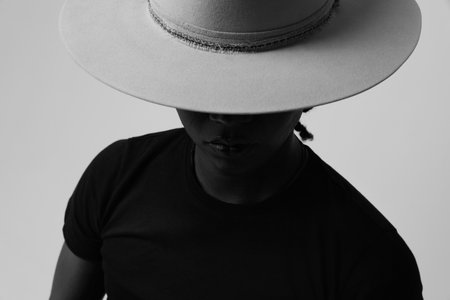 Black and white portrait of handsome young man wearing trendy hat. Isolated.の写真素材