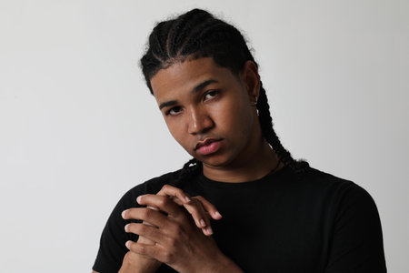 Portrait of serious young man posing in the studio and looking at the camera.の写真素材