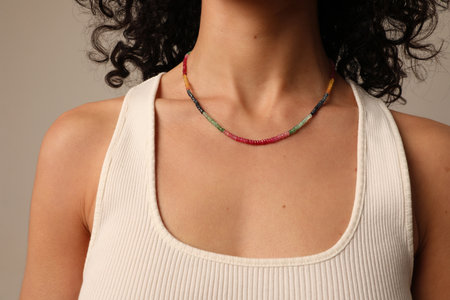 Close-up portrait of woman with a healthy skin wearing colourful necklace.の写真素材