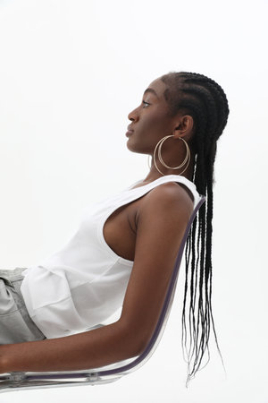 Vertical side portrait of young African woman, wearing big golden hoops. Mock-upの写真素材