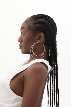 Side portrait of young African woman, wearing big golden hoops. Mock-up.の写真素材