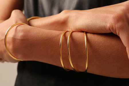 Close-up of female hands showing her finest golden bracelet. Horizontal mock-up.の写真素材