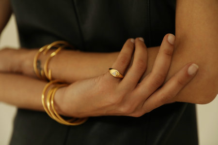 Close-up of female hands showing her golden bracelet. Horizontal mock-up.の写真素材