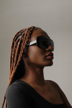 Gorgeous young African American woman with braids posing on white background.の写真素材