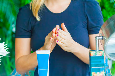 Woman hand applying cream on the other handの写真素材