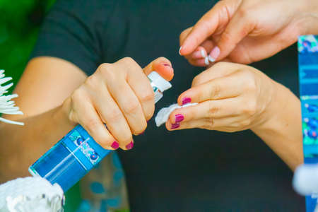 Woman hand applying cream on the other handの写真素材