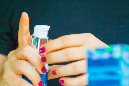 Woman hand applying cream on the other handの写真素材