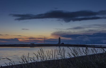 Grotta Island Lighthouse, located off the Atlantic Ocean coast near the city of Reykjavik, Iceland, at sunset.の写真素材