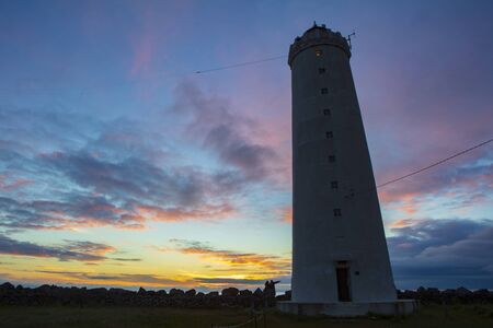 Grotta Island Lighthouse, located off the Atlantic Ocean coast near the city of Reykjavik, Iceland, at sunset.の写真素材