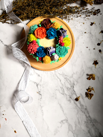 Colourful Flower Cake on Wooden Tableの写真素材