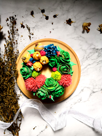 Colourful Flower Cake on Wooden Tableの写真素材