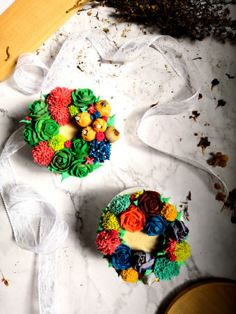 Colourful Flower Cake on Wooden Tableの写真素材