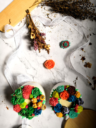 Colourful Flower Cake on Wooden Tableの写真素材