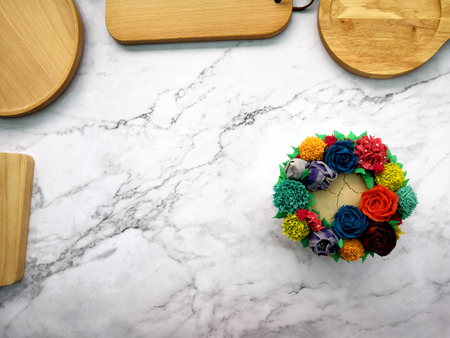 Colourful Flower Cake on Wooden Tableの写真素材