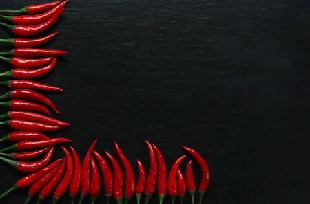 Photography of red hot peppers on slate background for restaurant menuの写真素材