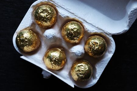 Photography of chocolate easter eggs wrapped in gold foil for food illustrations