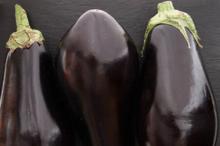 Photography of three eggplants on slate background for food illustrationsの写真素材