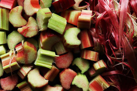 Macro photography of a bunch of fresh cut organic rhubarb stalks and rhubarb wastes for food backgroundの写真素材